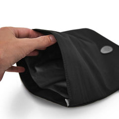 A persons hand opening the top of the pacadry bag 