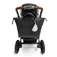 Saunton backpack black hanging from the pram with pram clips